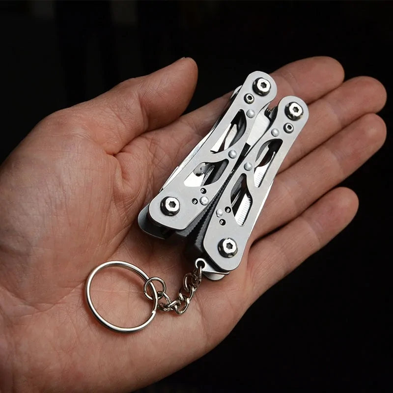 Compact foldable tactical survival tool with multifunction capabilities, made from durable 420 stainless steel for outdoor and emergency use.