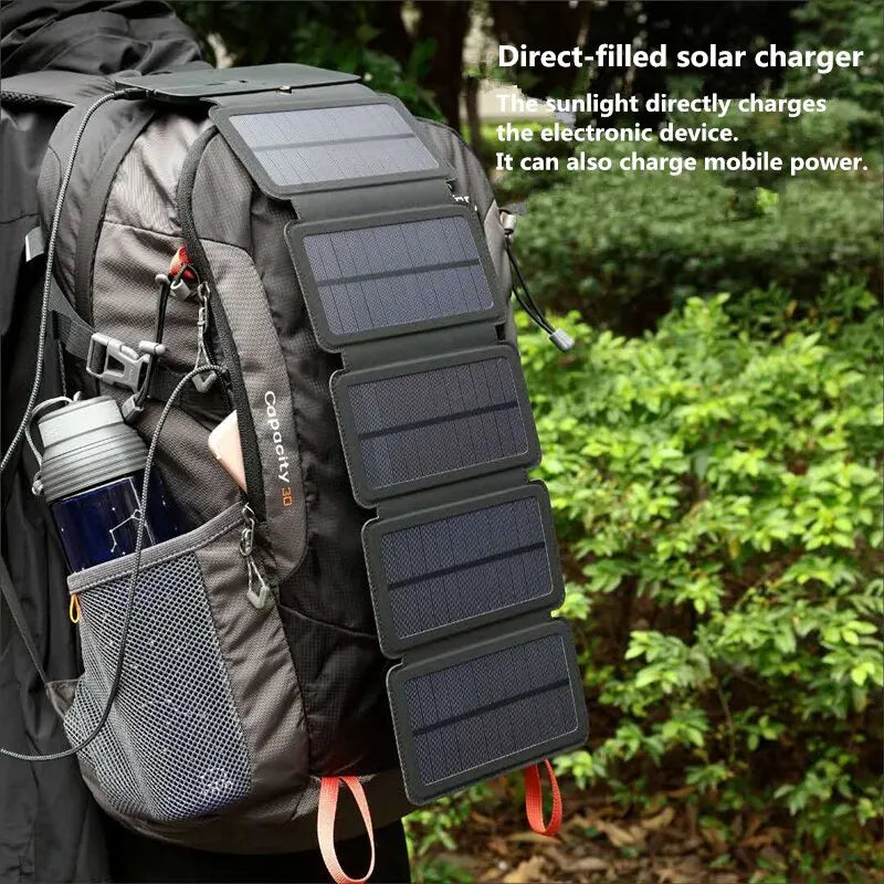 The solar panel charger unfolded in the sun, charging a smartphone.