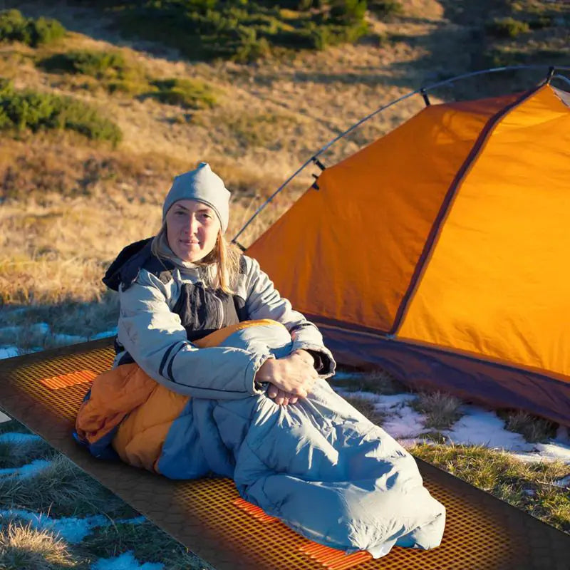 Outdoor USB Heating Sleeping Mat being used in a cold outdoor environment.