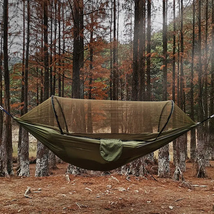 The mosquito net fully set up over a bed or cot.