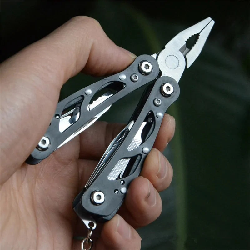 Compact foldable tactical survival tool with multifunction capabilities, made from durable 420 stainless steel for outdoor and emergency use.